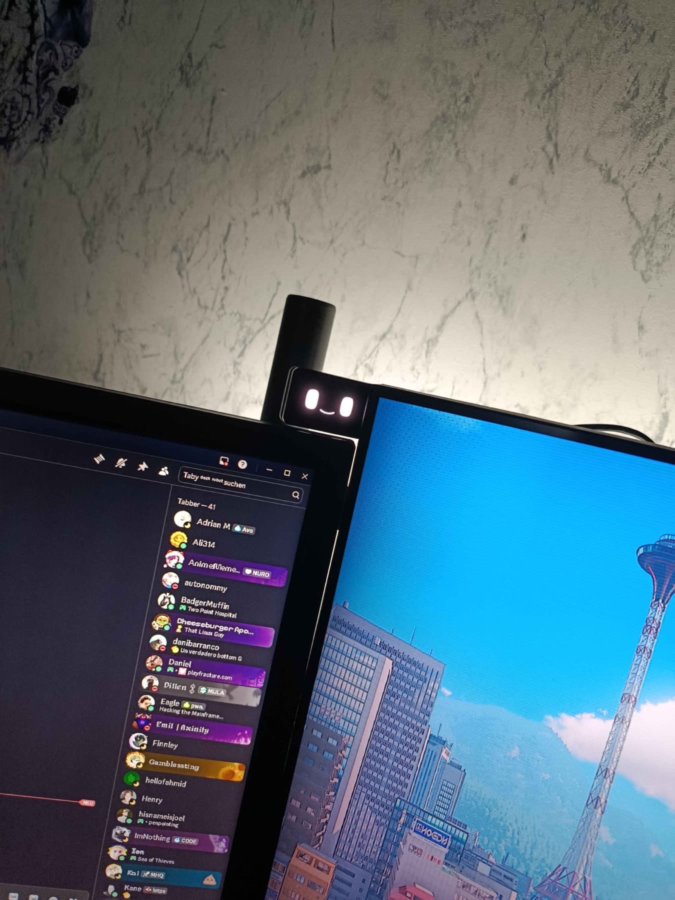 Taby attached between two monitors.